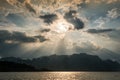 Beautiful sun rays through the clouds over mountains,evening light,Amazing scene at Khao-Sok National Park of Thailand Royalty Free Stock Photo