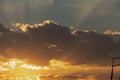 Beautiful Sun rays coming out of the clouds during evening time with yellow color clouds in sky