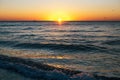 Beautiful sun rise and sea waves foam closeup at sandy beach with seashells tropical island. Waves in ocean at sunset light. Royalty Free Stock Photo