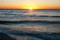 Beautiful sun rise and seagulls flying in red sky above sea waves on tropical island. Waves in ocean at sunset light. Tranquil Royalty Free Stock Photo