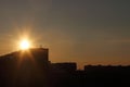 Beautiful sun during sunset over roofs of residential buildings