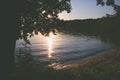 Beautiful sunlight through tree leaves and lake view in front Royalty Free Stock Photo