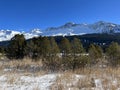 Beautiful sunlit and snow-capped alpine peaks above the tourist sports-recreational winter resorts of Valbella and Lenzerheide Royalty Free Stock Photo