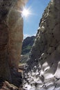 Beautiful sunny abstract rocky mountain scenery with a cleft between snow and rock