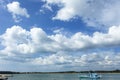 Beautiful sunny day with blue sky white clouds over the sea and fishing boat Royalty Free Stock Photo