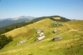 Beautiful sunny day in Carpathian Mountains. Nature in Carpathians. Green meadows, forests and little houses in mountains. Royalty Free Stock Photo