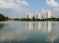 A beautiful sunny day at the lake in the park with buildings reflected on water Royalty Free Stock Photo