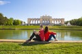 Beautiful sunny day, Sch nbrunn Palace, residence in Vienna, Austria. A girl and a guy are sitting near the fountain. Royalty Free Stock Photo