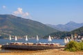 Beautiful sunny Mediterranean landscape with beach umbrellas. Summer beach vacation. Montenegro, Bay of Kotor Royalty Free Stock Photo