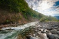 Beautiful sunny summer landscape. Fast flowing mountain river Royalty Free Stock Photo