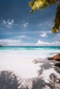 Beautiful sunny tropical sandy beach. Palm trees, blue sky and white clouds. Holiday vacation concept Royalty Free Stock Photo