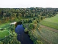 A beautiful sunny view of the forest, fields and river from above with a drone Royalty Free Stock Photo