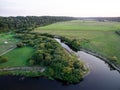 A beautiful sunny view of the forest, fields and river from above with a drone Royalty Free Stock Photo