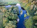 A beautiful sunny view of the forest, fields and river from above with a drone Royalty Free Stock Photo