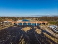 Beautiful sunny view of river wenta flowing towards old brick bridge in old historic countryside city Kuldiga Royalty Free Stock Photo