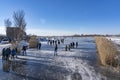 During this beautiful sunny winter day it gets quite busy with people who are ice skating on the ice of this lake in Zoetermeer Royalty Free Stock Photo