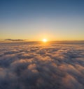 Beautiful sunrais cloudy sky from aerial view. Airplane view above clouds