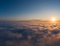 Beautiful sunrais cloudy sky from aerial view. Airplane view above clouds Royalty Free Stock Photo