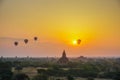 A beautiful sunrise with balloons floating in the air in Bagan is a city of thousands of Buddhist pagodas. Royalty Free Stock Photo