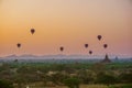 A beautiful sunrise with balloons floating in the air in Bagan is a city of thousands of Buddhist pagodas. Royalty Free Stock Photo