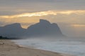 Beautiful sunrise on the beach of Barra da Tijuca with the stone of GÃÂ¡vea in the background Royalty Free Stock Photo