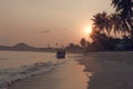 Beautiful sunrise at beach resort. Warm sun glow. palm trees in the background Royalty Free Stock Photo