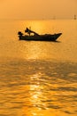 .Beautiful sunrise on the beach and silhouette of fishing boat.Thailand Royalty Free Stock Photo