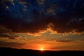 Beautiful sunrise behind clouds and the mountains