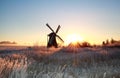 Beautiful sunrise behind windmill in winter Royalty Free Stock Photo