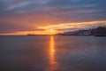 A beautiful sunrise bursts over the smooth sea at the old swanage pier Royalty Free Stock Photo