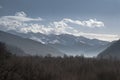 Beautiful sunrise in Caucasus mountains in winter. Mountain ridges highlighted the low winter sun. Royalty Free Stock Photo