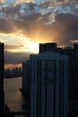 Beautiful sunrise in downtown miami. the sun breaks through the clouds and skyscrapers. view from the 38th floor