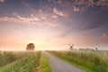 Beautiful sunrise on Dutch farmland with windmill Royalty Free Stock Photo