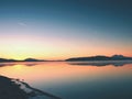 Beautiful sunrise at empty beach, Mediterranean Sea island. Peaceful water level makes mirror Royalty Free Stock Photo