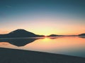 Beautiful sunrise at empty beach, Sea island. Peaceful water level makes blue mirror Royalty Free Stock Photo