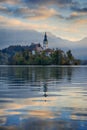 Beautiful sunrise landscape of famous mountain lake Bled in Slovenia with church on small green island Royalty Free Stock Photo