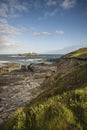 Beautiful sunrise landscape image of Godrevy in Corwnall England