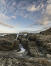 Beautiful sunrise landscape image of Godrevy in Corwnall England