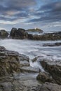 Beautiful sunrise landscape image of Godrevy in Corwnall England