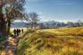 Beautiful sunrise light over the field, excursionist going the road Royalty Free Stock Photo