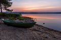 Beautiful sunrise on the like with boat on foreground