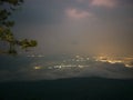 Beautiful sunrise with Loei City light and sea of mist in the early morning on Phu Kradueng mountain Royalty Free Stock Photo