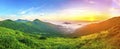 Beautiful sunrise in mountains with white fog below panorama Royalty Free Stock Photo