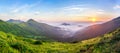 Beautiful sunrise in mountains with white fog below panorama Royalty Free Stock Photo