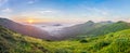 Beautiful sunrise in mountains with white fog below panorama Royalty Free Stock Photo