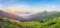 Beautiful sunrise in mountains with white fog below spring summer panorama Royalty Free Stock Photo