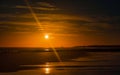 The beautiful sunrise, orange sky and clouds over the Blyth Beach with reflection of sun in the water Royalty Free Stock Photo