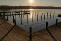 Beautiful sunrise over a dock by a calm, serene Lake Bagsvaerd