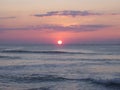 Beautiful sunrise over gray color ocean with orange color horizon