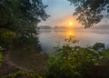 Beautiful sunrise over misty lake. Royalty Free Stock Photo